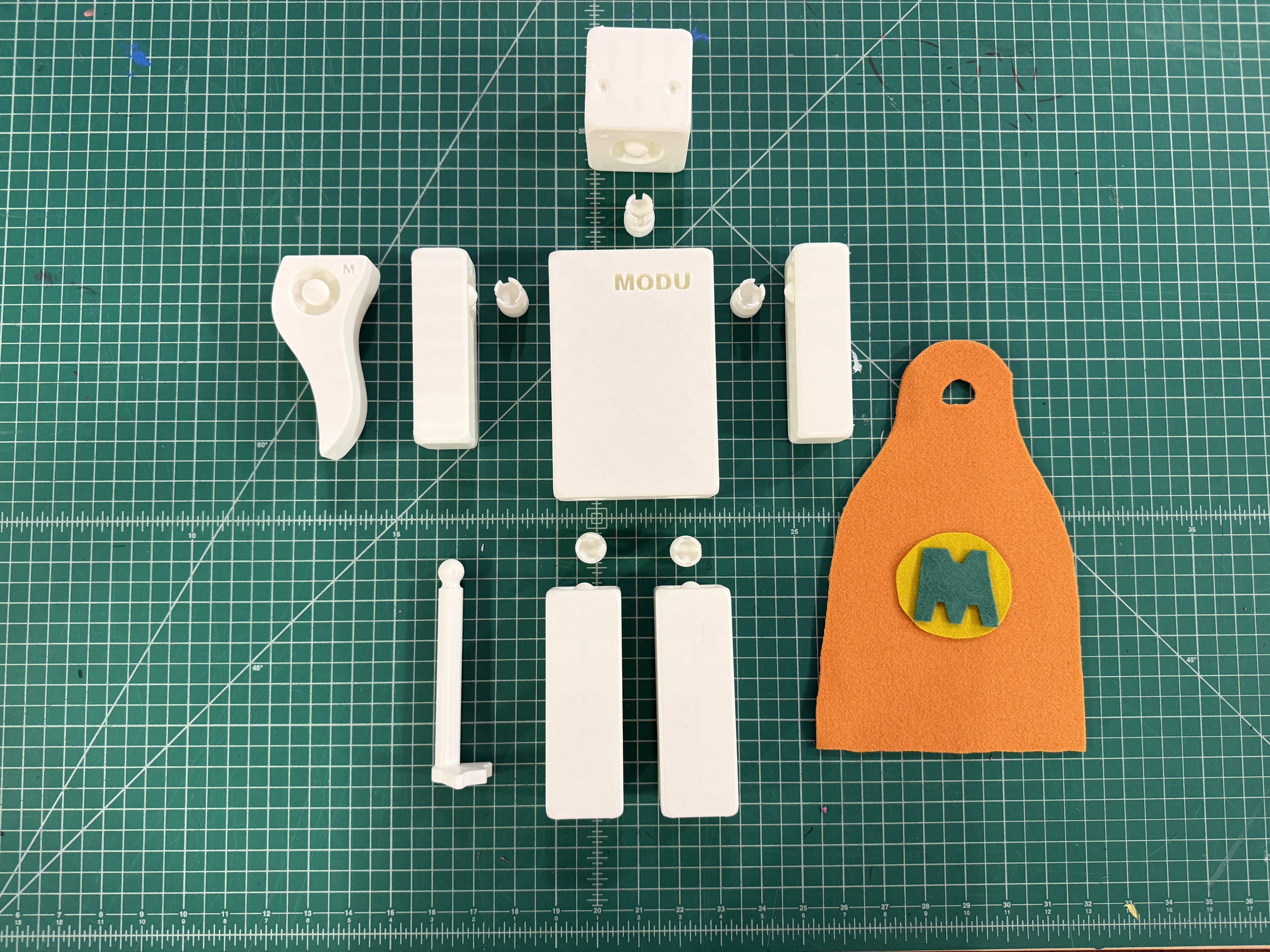 MODU modular prototype components arranged on a green cutting mat